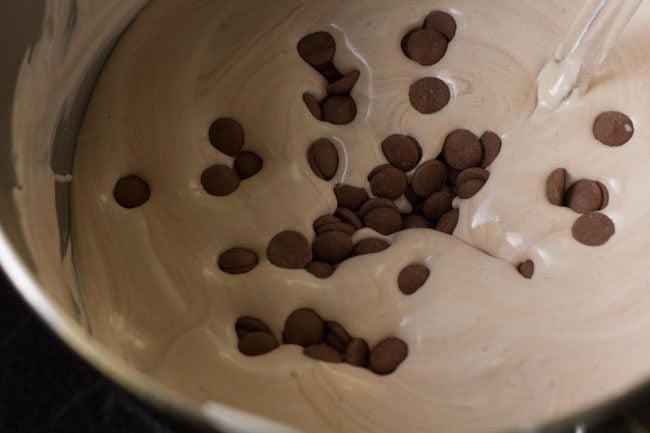 adding chocolate chips to the chocolate-cream mixture 