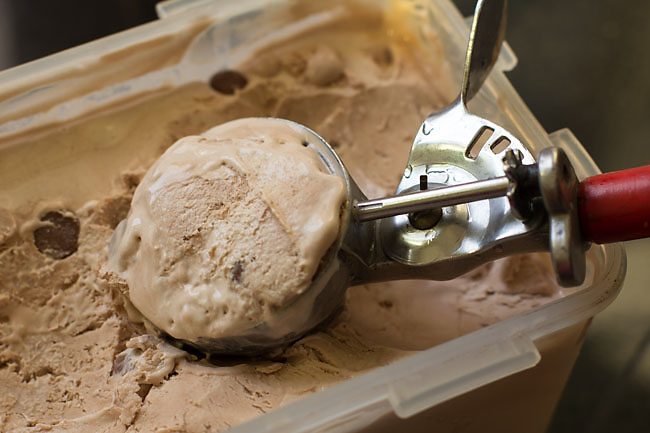 scooping out chocolate chip ice cream 