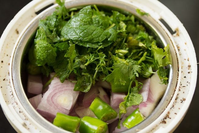 onions and herbs added to grinder jar