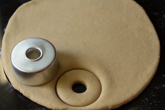 making donut using a donut cutter