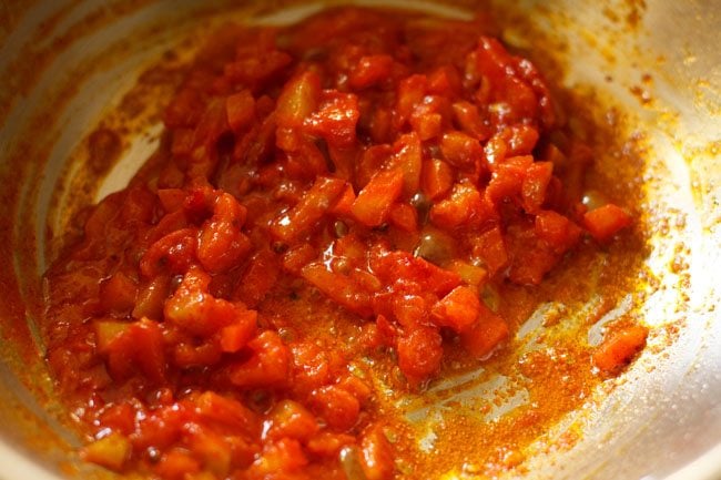 mixing tomatoes with spices