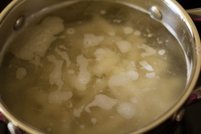 fusilli pasta in water in the pan