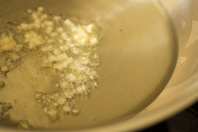 finely chopped garlic getting sautéed in oil