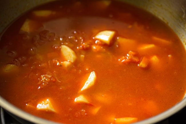 water added to potatoes and mixed to make aloo curry