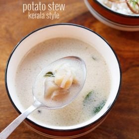 potato stew served in a blue rimmed ceramic bowl with some in a spoon and text layovers.