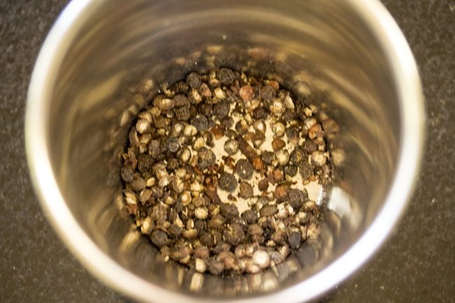 crushed black peppercorns and cloves in a mortar. 