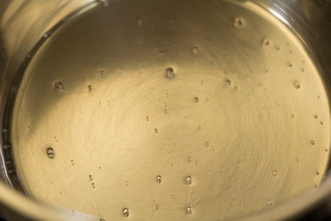 heating coconut oil in a pan. 