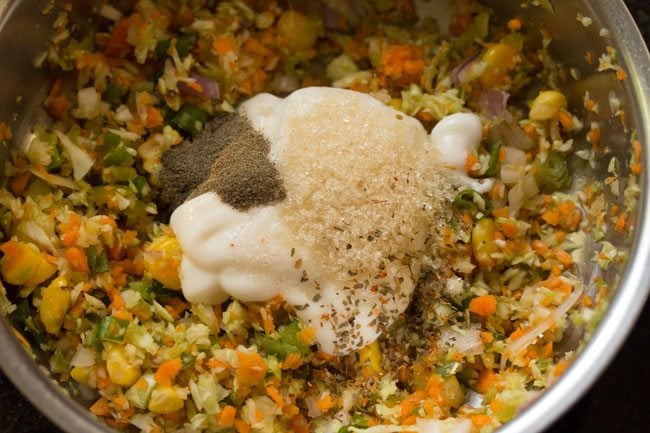 seasonings added to mix veggies in the bowl