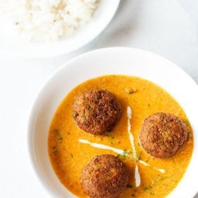 veg kofta curry served in a white bowl..