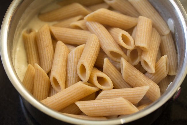 cooked pasta added in the white sauce.