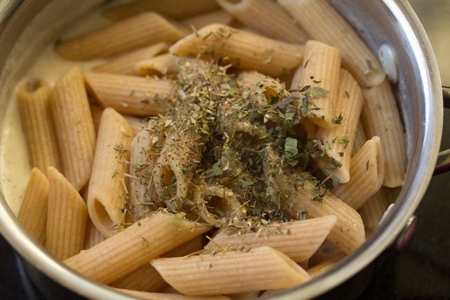 dried herbs like oregano, parsley and thyme added on the pasta. 