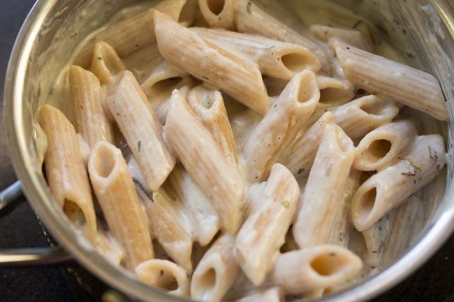 pasta mixed with white sauce and herbs. 