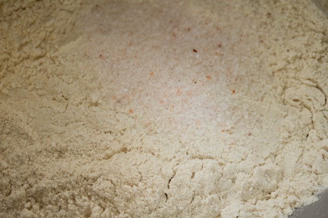 salt added on top of flour to prevent it from killing the yeast.