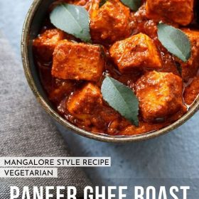 paneer ghee roast garnished with curry leaves and served in a bowl with text layovers.
