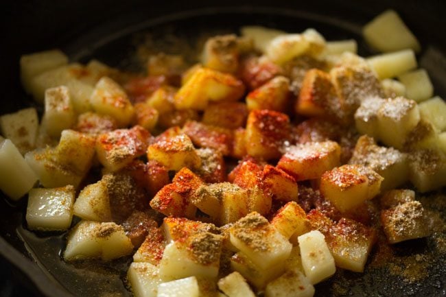 add ground spices to potatoes