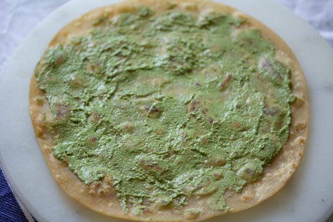 creamy green chutney spread all over the roti.