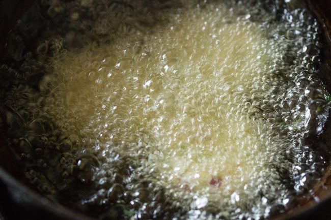 frying bread vada in hot oil