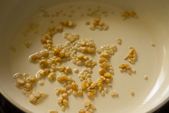 chana dal and urad dal in a pan