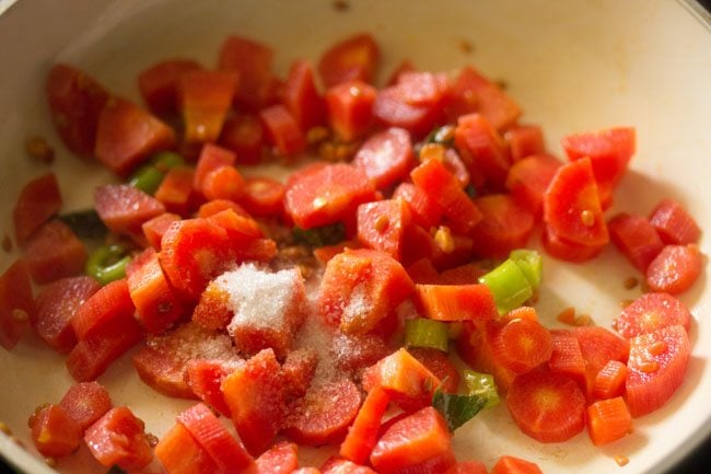 salt added to carrots in the pan