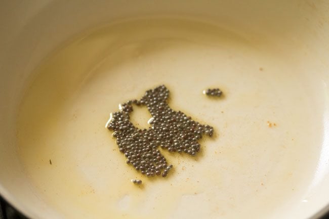 crackling mustard seeds in the pan