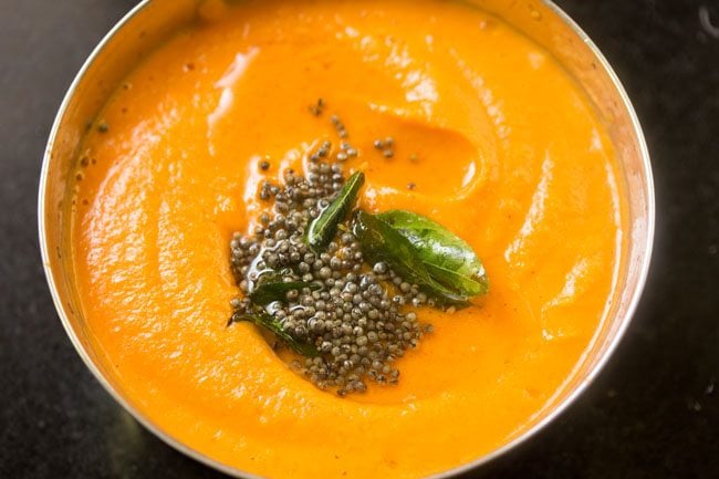 carrot chutney in a bowl with the tempering