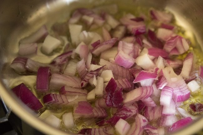 onions sautéing in a pan with olive oil.