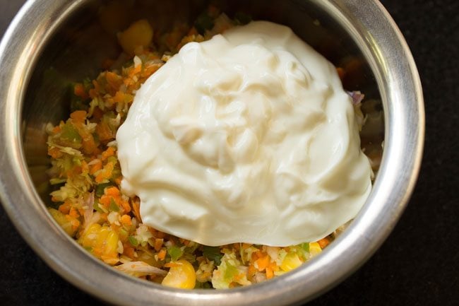 thick curd added to the mixed vegetables in the bowl.