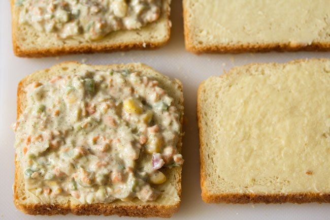 stuffing spread on buttered bread slices.