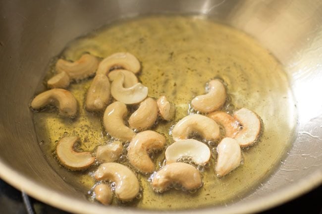 frying cashews in hot ghee. 