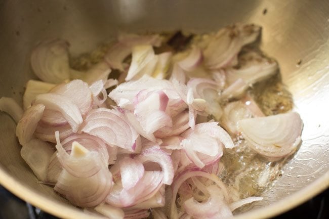 thinly sliced onions added to hot ghee. 