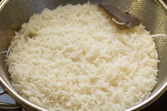 draining cooked rice in a colander. 