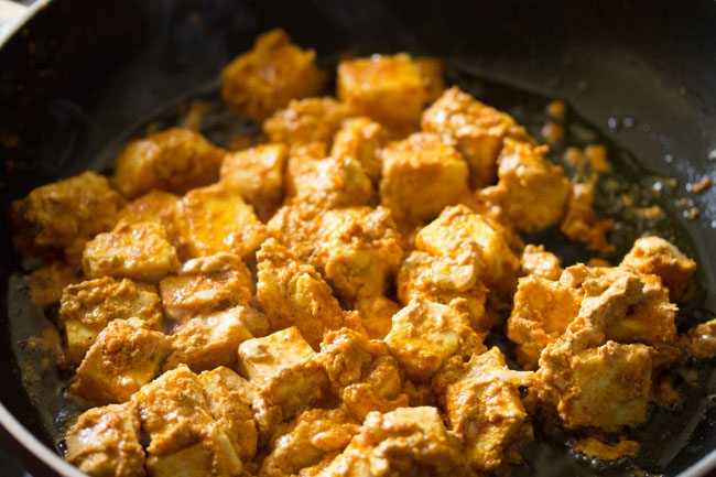 frying paneer cubes are getting darker.