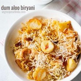 aloo biryani served in a white plate. with a bowl of raita kept on the top left side and text layovers.