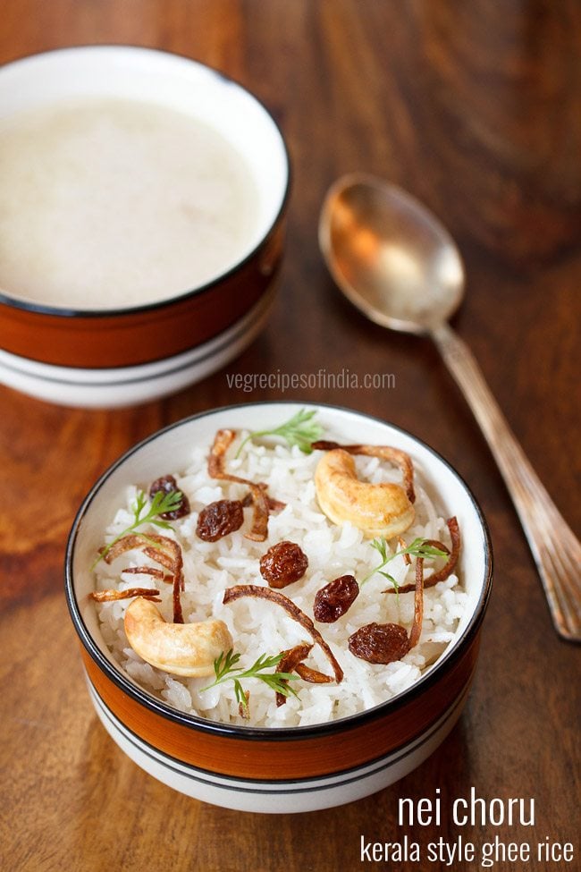 kerala nei choru garnished with fried cashews, fried raisins, fried onions, coriander leaves and served in a blue rimmed bowl with text layovers.