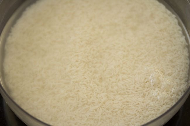 soaking kaima rice in water to make neychoru.