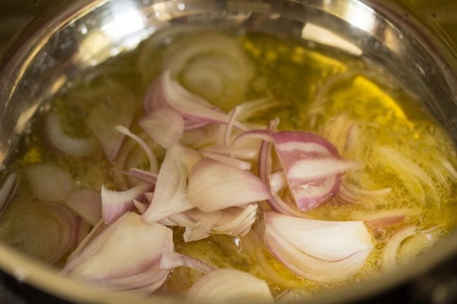 thinly sliced onions added to the melted ghee in pan. 