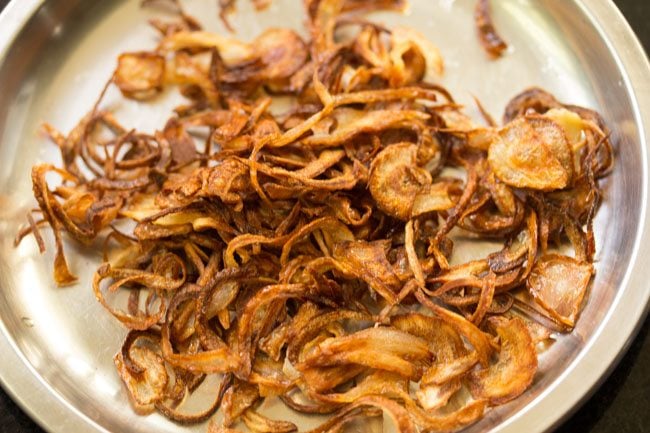 fried onions on a steel plate for neychoru.
