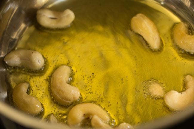 cashews added in the hot ghee in pan. 