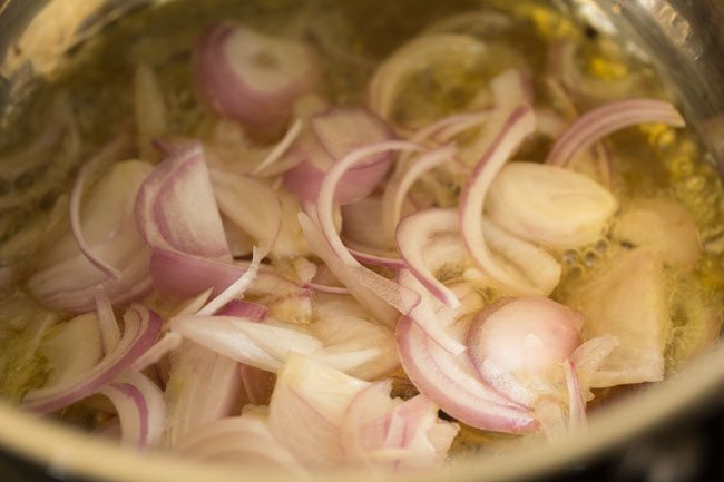 thinly sliced onions added to the hot ghee. 