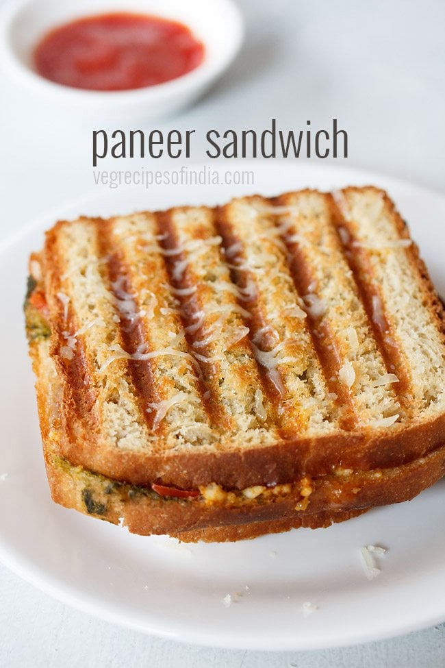 paneer sandwich with cheese served on a white plate with text layovers.