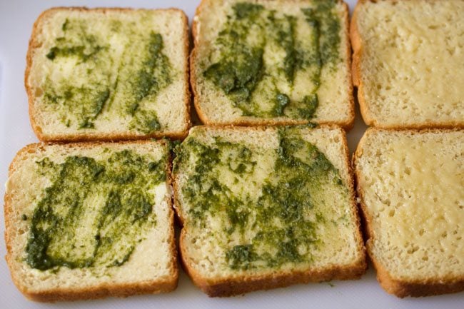 prepared coriander chutney spread on buttered bread slices. 