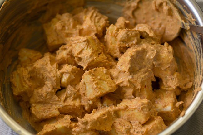 paneer tikka marinating in a bowl.