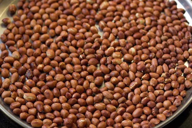 roasted peanuts cooling down in a steel plate