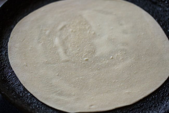 roti is placed on a hot tawa.