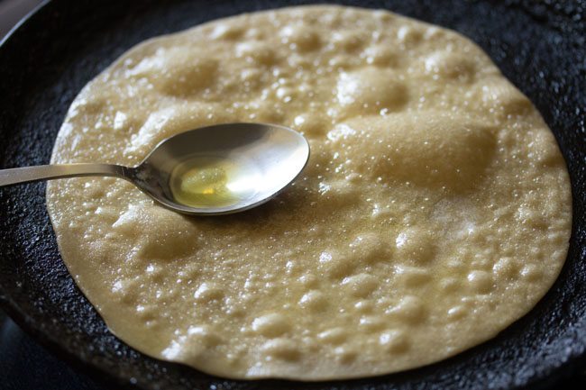 brushing oil on the roti, which is now getting larger bubbles.