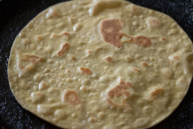 roti has golden brown blisters across the top and is now ready for making paneer kathi roll recipe.