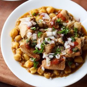 samosa chaat served on a white plate.