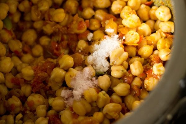 mixing chickpeas with the masala