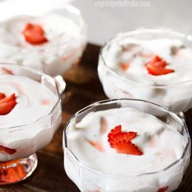 strawberry cream garnished with fresh strawberry slices and served in ice cream cups.