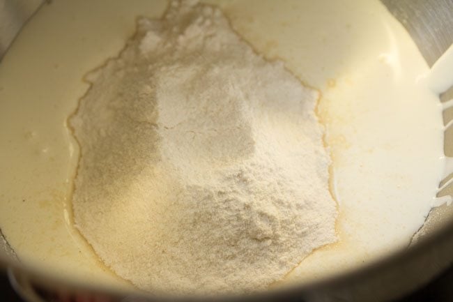 chilled cream and powdered sugar added in a bowl. 